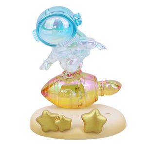 Iridescent astronaut surfing rocket desk ornament with gold star base for ipad phone