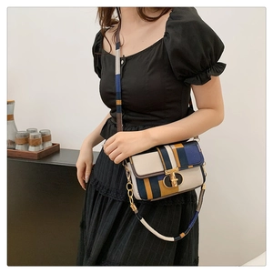 Detail of color-block plaid crossbody bag with gold metallic lock and chain strap