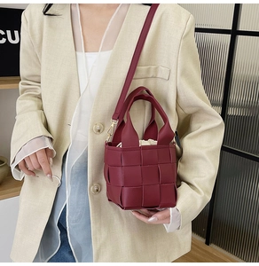 Vue détaillée du sac à main tressé bordeaux avec doublure en toile beige