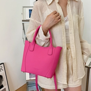 Sac seau fuchsia en cuir grainé avec poignées et bandoulière réglable élégante
