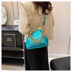Green metallic textured crossbody bag with gold chain handle and vintage kiss-lock closure
