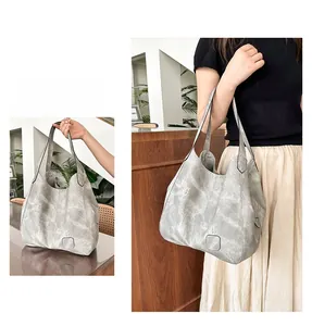 Detail of grey tote bag with washed stone texture and adjustable shoulder straps