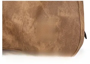 Close-up of vintage brown PU leather texture and debossed logo on large shoulder bag