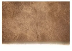 Detailed macro shot of brown soft leather stitching and high-quality fabric texture