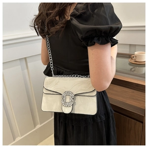 Detail of white marble pattern crossbody bag with a large sparkling crystal square buckle
