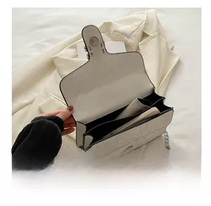 Interior view of marble pattern crossbody bag showing multi-layer compartments for smartphone
