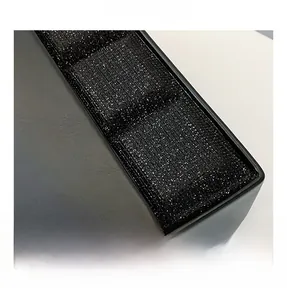 Detail of black sequined fabric and matte leather on a stylish chocolate box bag