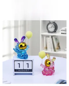 Iridescent electroplated astronaut bunny ornaments in blue and pink on desk display