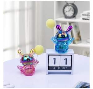 Detail view of colorful laser plating rabbit astronaut figurines with balloon accents