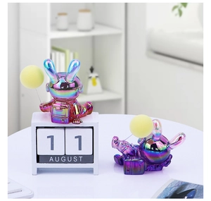 Detail of creative astronaut rabbit figurine with vibrant rainbow plating and yellow orb