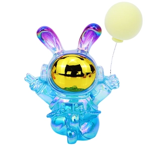 Iridescent blue astronaut rabbit figurine with gold visor and balloon for desk decor