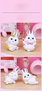 Detail of hand-painted resin bunny figurines with colorful rhinestone-embellished ears