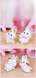 Detail of cute white resin rabbit figurines with sparkling rhinestone-inlaid ears