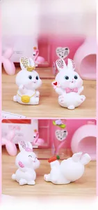 Detailed view of four cute white resin rabbit figurines in various decorative poses