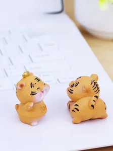Nahaufnahme süßer Mini-Tiger-Deko aus Harz auf einer Laptop-Tastatur im Büro