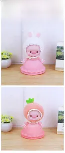 Cute pig piggy bank detail with plush bunny ears and strawberry hat accessories