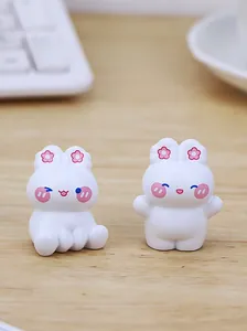 Pair of cute white bunny figurines with pink flower accents for desktop decor