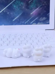 Set of four cute mini white rabbit figurines displayed on a sleek laptop keyboard