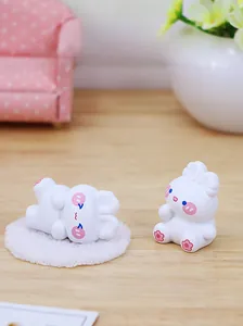 Close-up of cute white resin rabbits on mini sofa for desk or car dashboard decor