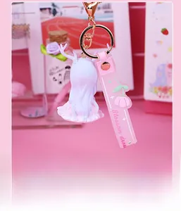 Close-up of Blossom dream cartoon deer girl keychain with pink wrist strap and gold clip