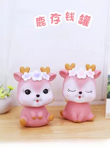 Detailed close-up of cute pink deer piggy banks with flower crowns and heart antlers