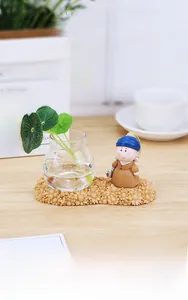 Detail of Girl with a Pearl Earring resin figure on a sunflower base with glass vase