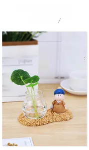Detail of Girl with a Pearl Earring figurine and glass hydroponic vase on daisy base
