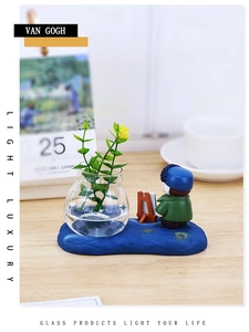 Detail of Van Gogh artist figurine with mini glass hydroponic vase and wooden easel