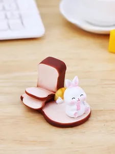 Macro detail of creative toast bunny desk ornament with matte resin texture on wood table