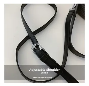 Detail of adjustable black leather strap with silver metal buckle on shoulder bag