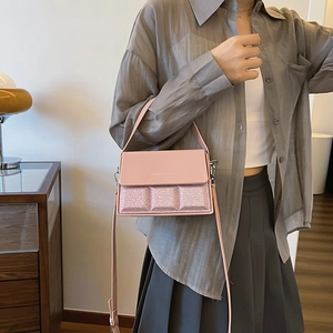 Chic pink chocolate-style crossbody bag with glitter textures and adjustable strap