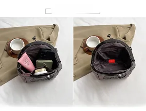 Detail view of the purple vintage shell bag's interior showing main pocket and zipper pouch