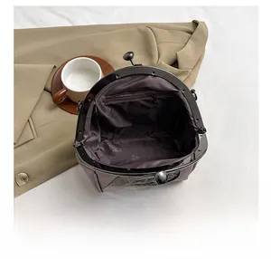 Interior view of vintage shell bag showing inner pocket and purple matte texture