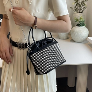 Sparkling black rhinestone bucket bag with drawstring closure and silver chain strap