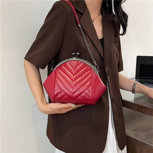 Red quilted shell crossbody bag with metal kiss-lock and silver chain strap for women