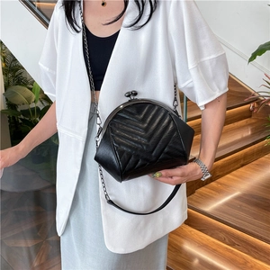 Chic black quilted shell bag with metallic chain strap and vintage clasp closure