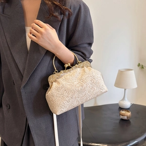 Elegant retro shell handbag with embossed floral texture and gold chain strap