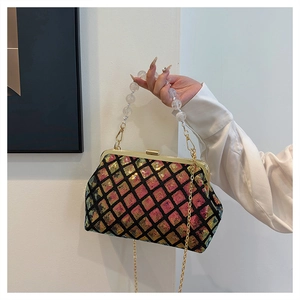 Detail of colorful sequin evening bag with pearl handle and golden metal clasp