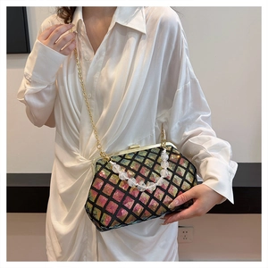 Detail of colorful sequin lattice pattern on vintage clasp bag with pearl handle