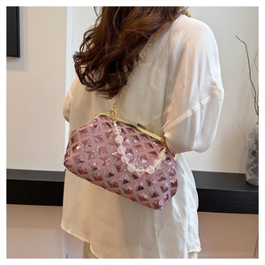 Detail of pink sequin evening bag with gold metal clasp and beaded handle strap