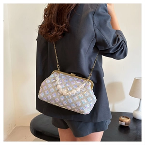 Detail of silver sequin lattice handbag featuring pearl handle and gold chain strap