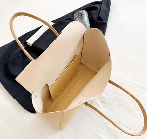 Top-down view of a spacious apricot tote bag showing interior main compartment and side pocket