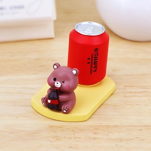 Cute cartoon bear phone holder with red storage cup on yellow base for desk