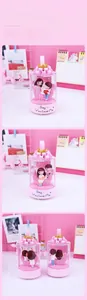 Detailed views of couple figurines inside a pink moon night light with floral accents