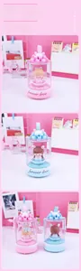 Detail of cute musical box night light with cartoon girl figurine and ribbon bow