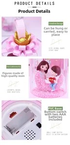 Detail of moon-shaped night light with resin cartoon couple and golden crown top handle