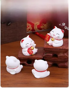 Set of four mini Maneki Neko lucky cat figurines with blessing signs on wooden stand