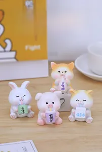 Close-up of four resin animal figurines holding mini drinks on a wooden table desk
