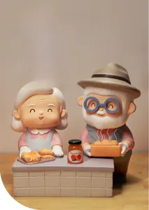 Detail of cute elderly couple figurines baking together with apricot jam jar decor