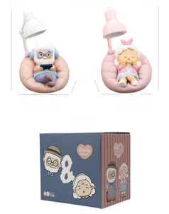Macro view showing dimensions of old couple night light figurine with gift box